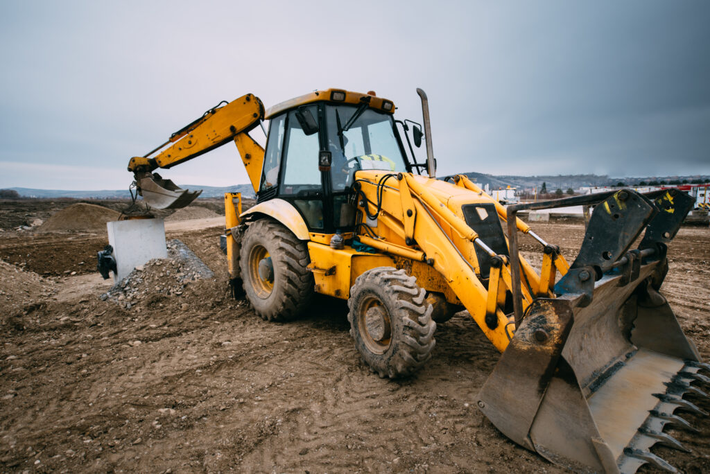 backhoe on construction site - equipment repair services